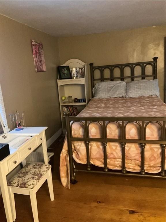 bedroom with dark wood-style floors