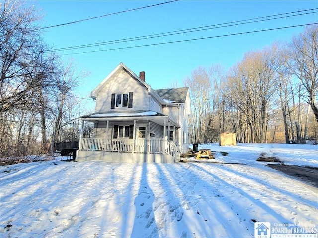 view of front of home featuring a porch and a chimney