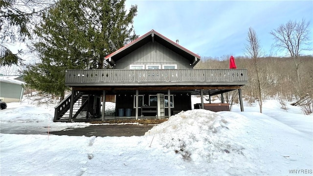 view of front of property featuring stairs and a deck