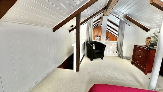 interior space with lofted ceiling with beams and wooden walls