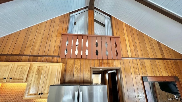 interior details featuring freestanding refrigerator and wooden walls