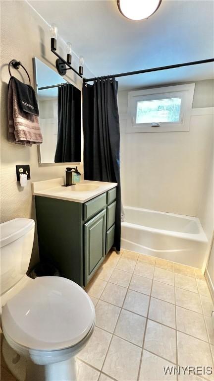 bathroom featuring vanity, tile patterned flooring, toilet, and shower / tub combo with curtain