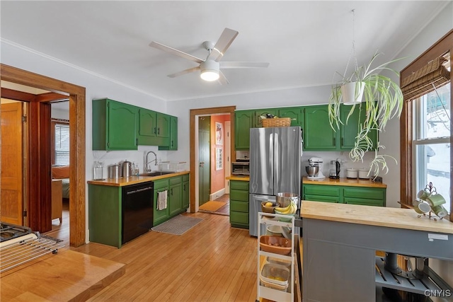 kitchen with light wood-style flooring, a sink, black dishwasher, freestanding refrigerator, and green cabinetry