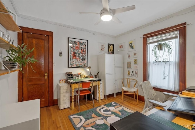 office area featuring baseboards, light wood-style flooring, and a ceiling fan