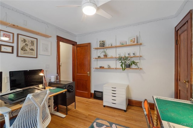 office area with light wood finished floors, baseboards, and a ceiling fan