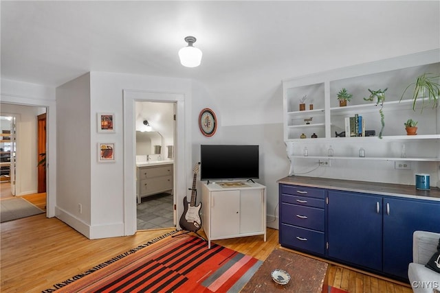 living room featuring light wood-type flooring and baseboards