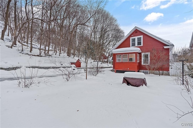 yard layered in snow featuring a garage