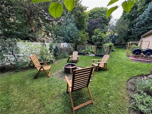 view of yard featuring fence and a fire pit