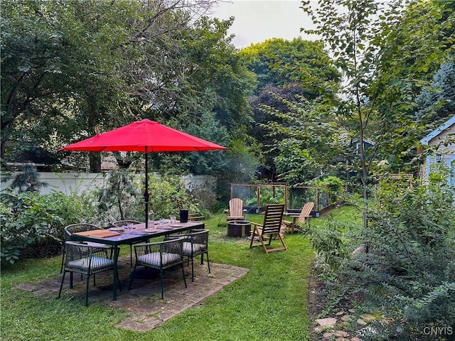 view of yard with fence and a fire pit