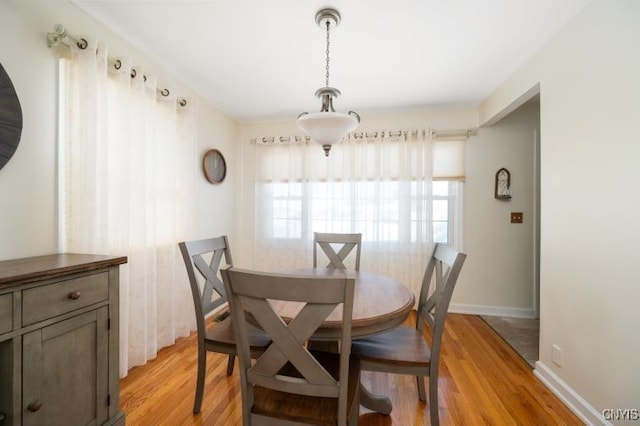 dining room with light wood-style flooring and baseboards