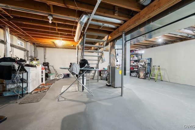 unfinished basement featuring heating unit and independent washer and dryer