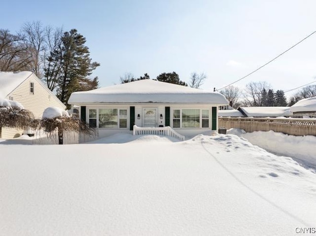 bungalow-style home featuring fence