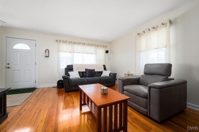 living area with wood finished floors and baseboards