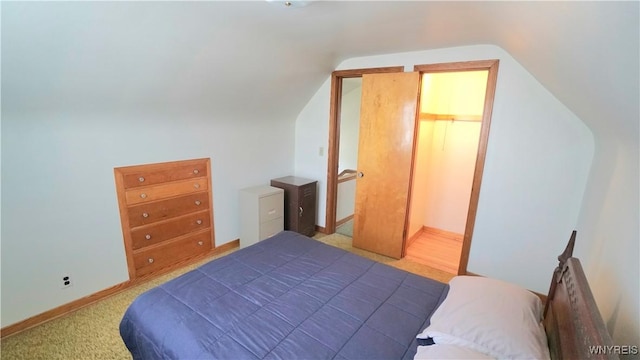 bedroom with baseboards and vaulted ceiling