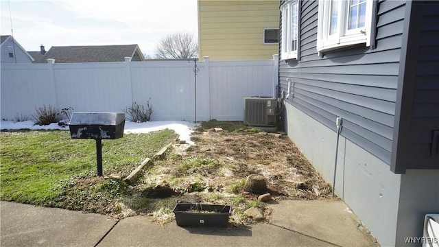 view of yard featuring cooling unit and fence