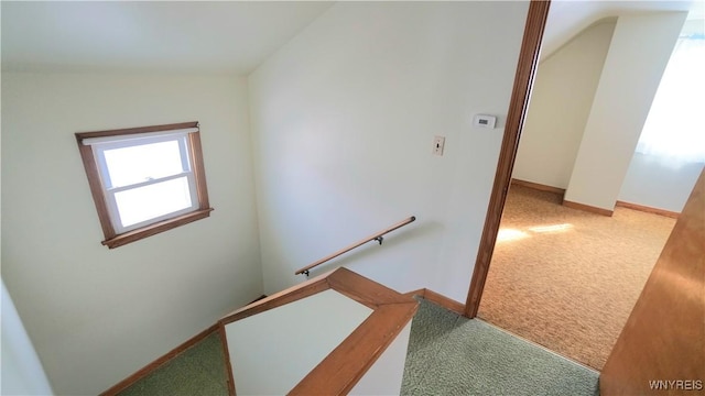 stairway featuring carpet flooring and baseboards