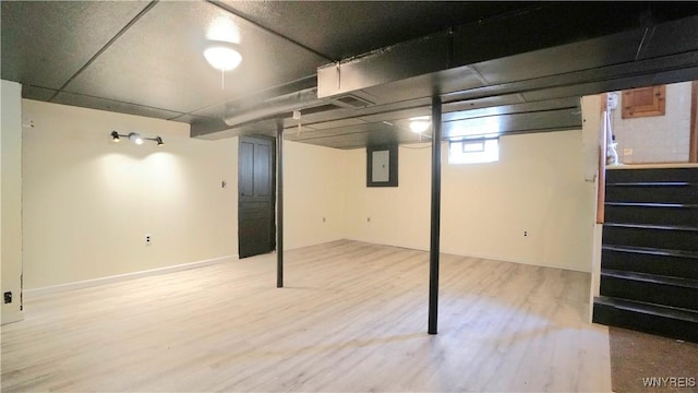 below grade area featuring wood finished floors and electric panel