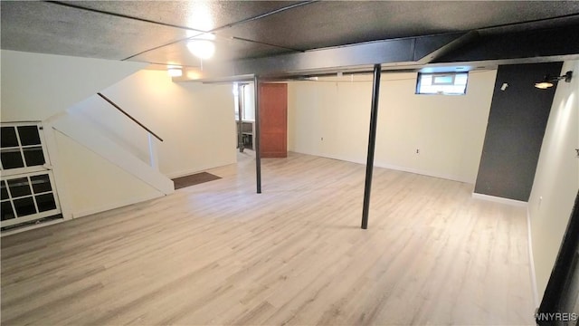 basement with stairway and wood finished floors