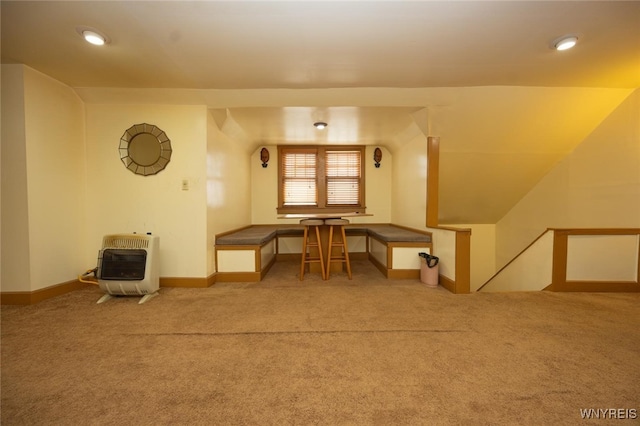 interior space with carpet, baseboards, and heating unit