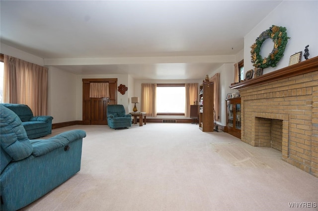 living room featuring carpet floors, a fireplace, and visible vents