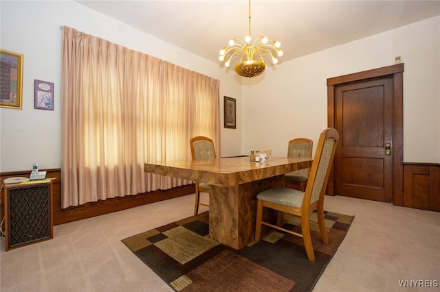 carpeted dining room with a notable chandelier