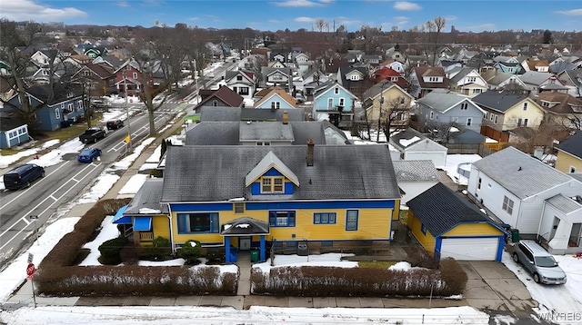 snowy aerial view with a residential view