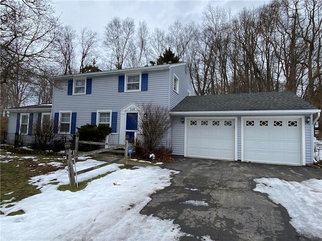 view of front of property featuring aphalt driveway and an attached garage