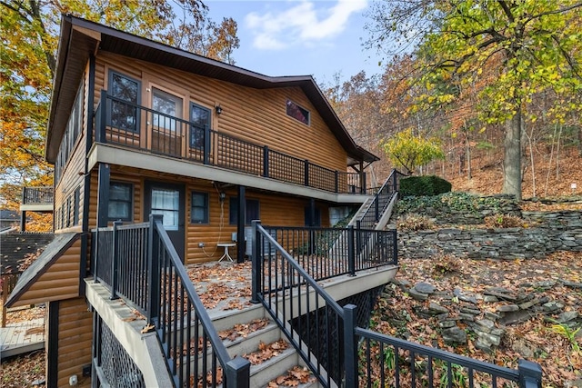 view of front of home with log veneer siding and stairway