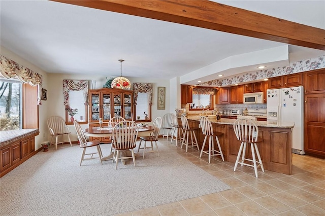 dining room featuring recessed lighting, a wealth of natural light, and light tile patterned flooring