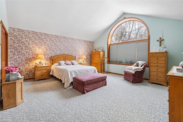 carpeted bedroom featuring lofted ceiling, wallpapered walls, and baseboards