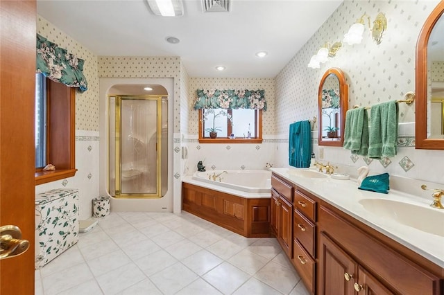 full bathroom featuring visible vents, a sink, and wallpapered walls