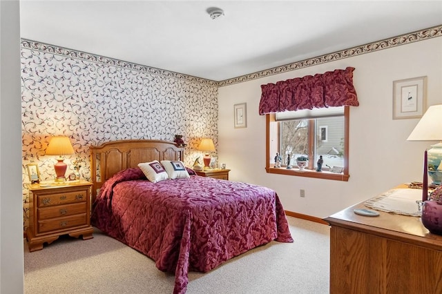 bedroom with light carpet and baseboards