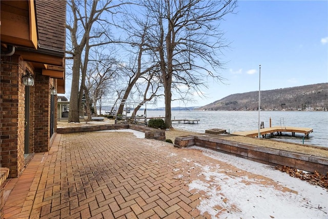 view of patio featuring a dock and a water view