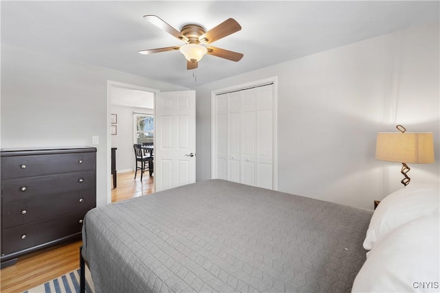 bedroom with ceiling fan, a closet, and light wood-type flooring