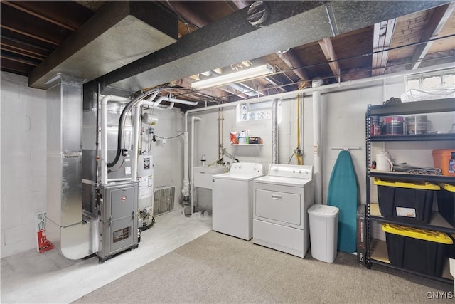 below grade area with washer and clothes dryer, gas water heater, and a sink