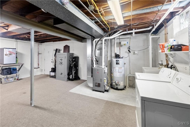 unfinished below grade area featuring washer and dryer, water heater, and heating unit