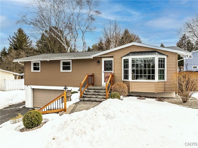 view of front of home with aphalt driveway and a garage