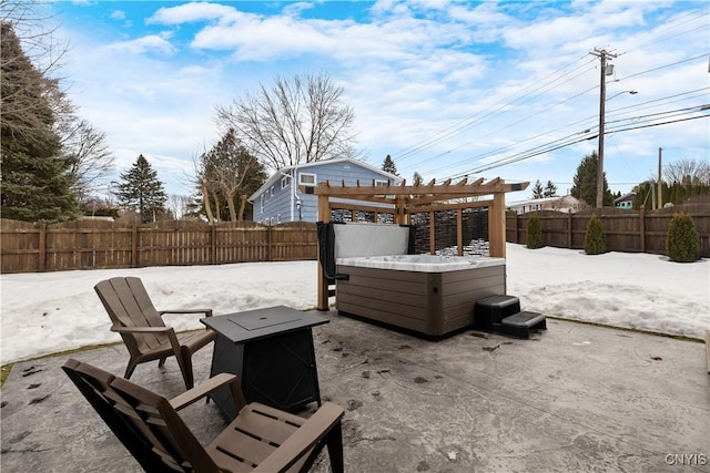 view of patio / terrace with a hot tub, a fenced backyard, and a pergola