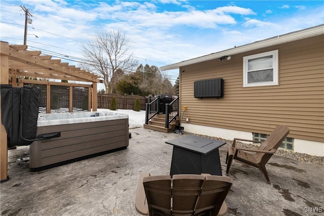 view of patio featuring fence, a hot tub, and a pergola