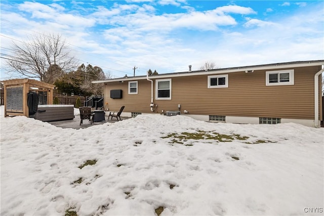 snow covered property featuring central AC, fence, and a pergola