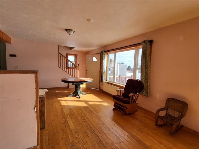 unfurnished room featuring stairs and hardwood / wood-style floors