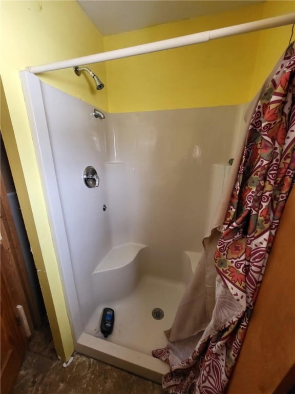 full bath with a shower stall