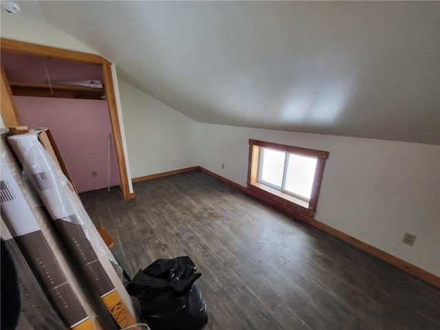 additional living space featuring lofted ceiling, wood finished floors, and baseboards