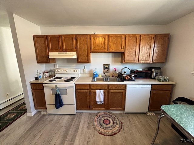 kitchen with light countertops, light wood-style floors, a sink, white appliances, and under cabinet range hood