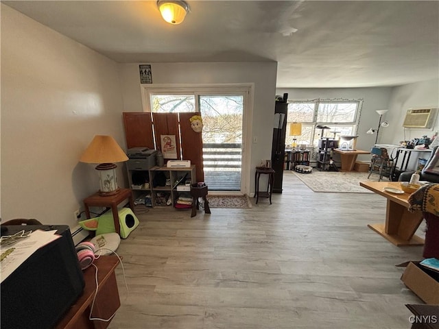 interior space featuring a wall mounted air conditioner and wood finished floors