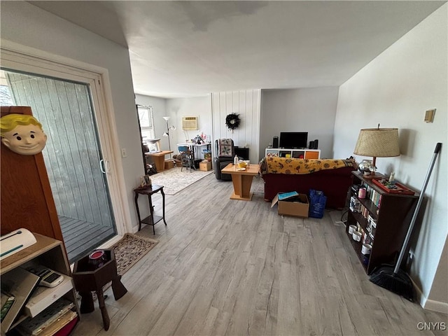 living room with wood finished floors and a wall mounted AC