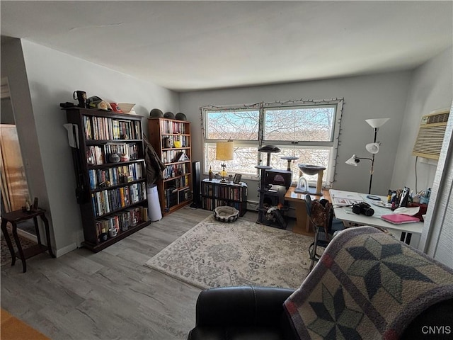 home office with baseboards and wood finished floors