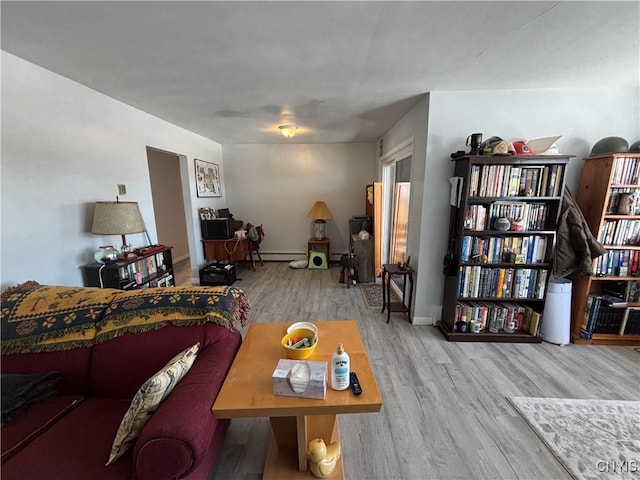 living area featuring baseboards and wood finished floors