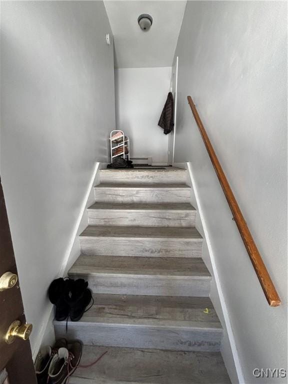 staircase featuring baseboards