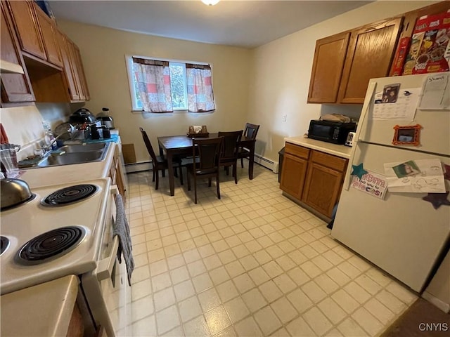 kitchen featuring a baseboard heating unit, white appliances, a sink, baseboard heating, and brown cabinets